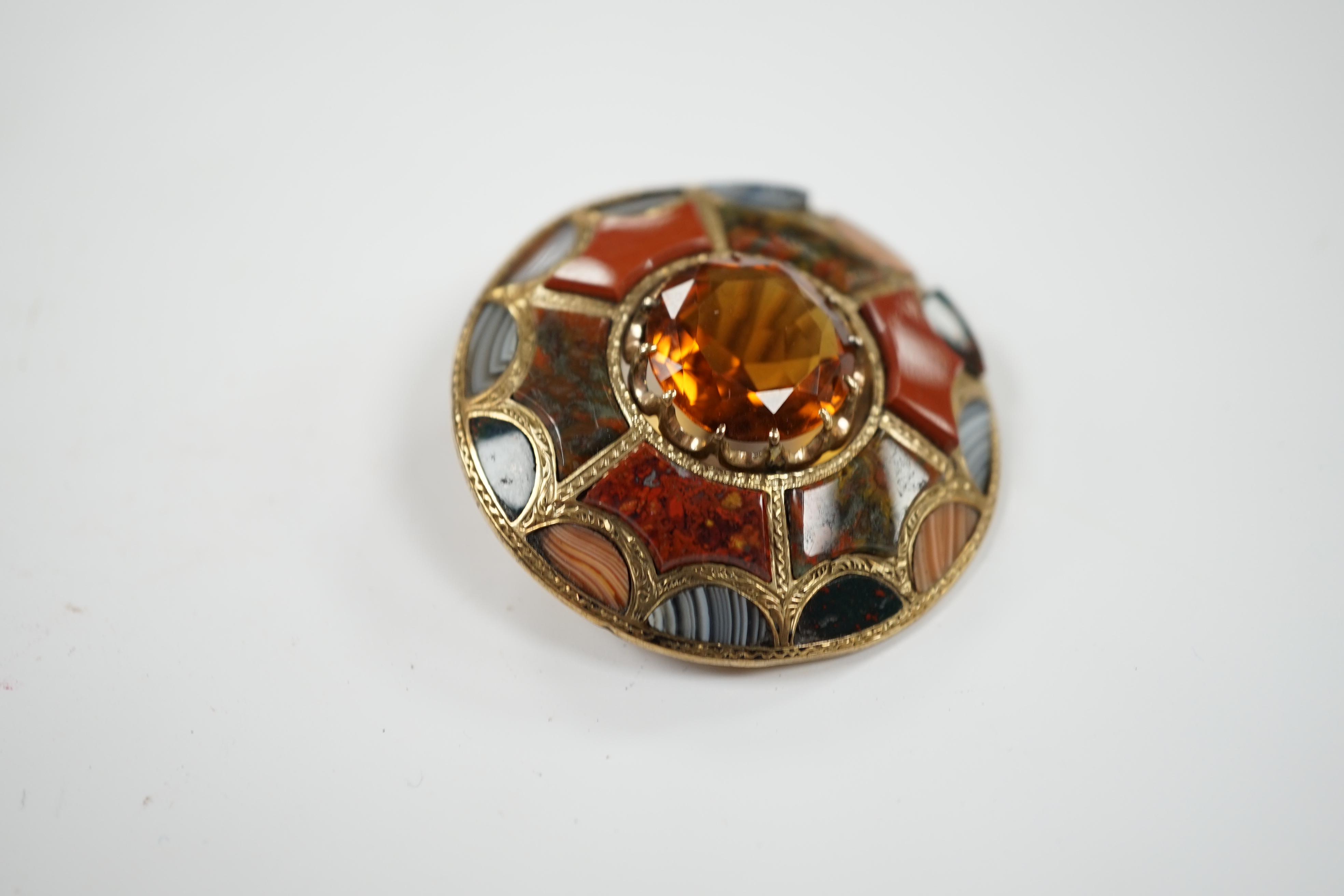 A Scottish yellow metal, citrine and Scottish hardstone set circular brooch, 41mm.